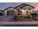 Inviting home exterior featuring a paver driveway, stone accents, and manicured landscaping at 8138 E Jacaranda St, Mesa, AZ 85207