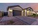 Beautiful home featuring a paver driveway, stone accents, and a well-maintained front yard at 8138 E Jacaranda St, Mesa, AZ 85207
