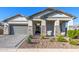 Inviting home featuring a paver driveway, stone accents, and manicured landscaping at 8138 E Jacaranda St, Mesa, AZ 85207