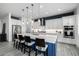 Modern kitchen with stainless steel appliances, blue island, white countertops, and pendant lighting at 8138 E Jacaranda St, Mesa, AZ 85207