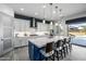 Stylish kitchen featuring a large island with bar seating and a view of the backyard pool area at 8138 E Jacaranda St, Mesa, AZ 85207