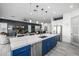 Open-concept kitchen with a blue island, stainless steel appliances, and seamless view to the living room at 8138 E Jacaranda St, Mesa, AZ 85207