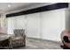 Bright living area with stylish sliding blinds, a cozy accent chair, and modern decor at 8138 E Jacaranda St, Mesa, AZ 85207