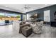 Comfortable living room featuring a plush sofa, patterned armchair, and sliding doors to the outdoor space at 8138 E Jacaranda St, Mesa, AZ 85207