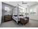 Serene bedroom featuring a four-poster bed, stylish nightstands, and ample natural light at 8138 E Jacaranda St, Mesa, AZ 85207