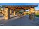 A covered community picnic pavilion has stone pillars, seating and concrete flooring at 8138 E Jacaranda St, Mesa, AZ 85207