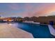 Beautiful backyard featuring a large pool with fountains, seating area, and lush landscaping at 8138 E Jacaranda St, Mesa, AZ 85207