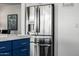Stainless steel refrigerator in a modern kitchen with white countertops and blue kitchen island at 8138 E Jacaranda St, Mesa, AZ 85207