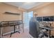 This spare bedroom is furnished as an office and has 2 black desks, shelves, and a gaming chair at 9352 W Pioneer St, Tolleson, AZ 85353
