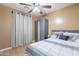 Charming bedroom featuring tiled floors, large windows, and a cozy grey wardrobe at 9352 W Pioneer St, Tolleson, AZ 85353