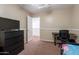 Comfortable bedroom with a ceiling fan, TV and easy access to the hallway at 9352 W Pioneer St, Tolleson, AZ 85353