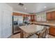 Open-concept kitchen with eat-in island, stainless steel appliances, and ample cabinet storage at 9352 W Pioneer St, Tolleson, AZ 85353