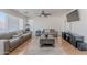 This living room features tile floors, neutral-toned furniture, and an entertainment center perfect for modern living at 9352 W Pioneer St, Tolleson, AZ 85353