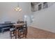 An open area with a staircase features a piano, a chess table and seating at 9352 W Pioneer St, Tolleson, AZ 85353