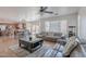 A living room is open to a kitchen with stainless appliances and a dining area at 9352 W Pioneer St, Tolleson, AZ 85353