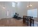 A living room features tall ceilings, large windows, and exercise equipment at 9352 W Pioneer St, Tolleson, AZ 85353
