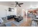 A living room features a staircase, and is open to a kitchen and dining area at 9352 W Pioneer St, Tolleson, AZ 85353
