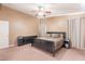 Neutral toned main bedroom featuring a large bed, dresser, and soft carpet perfect for unwinding at 9352 W Pioneer St, Tolleson, AZ 85353