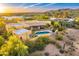 Aerial view displays home with pool, covered patios and desert landscaping at 9415 N 124Th St, Scottsdale, AZ 85259