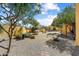 Sprawling backyard with lush landscaping, a sparkling pool, comfortable seating areas, and mature trees at 9415 N 124Th St, Scottsdale, AZ 85259