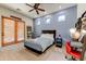 Well-lit bedroom with a red accent chair, three large windows and a modern color scheme for a relaxing atmosphere at 9415 N 124Th St, Scottsdale, AZ 85259