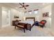 Bright bedroom features a ceiling fan, natural lighting and neutral color scheme with a unique decorative bench at 9415 N 124Th St, Scottsdale, AZ 85259