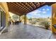 Expansive covered patio with outdoor seating, a built-in BBQ, and views of the lush backyard and pool at 9415 N 124Th St, Scottsdale, AZ 85259