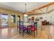 Bright dining area featuring hardwood floors, rustic beams, and views to the outside at 9415 N 124Th St, Scottsdale, AZ 85259