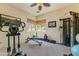 Well-equipped exercise room offering a variety of fitness equipment and ample natural light, perfect for a home gym at 9415 N 124Th St, Scottsdale, AZ 85259