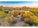 Exterior home view showcasing natural landscaping and mountain views at 9415 N 124Th St, Scottsdale, AZ 85259