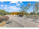 Attractive Southwestern-style home featuring a circular driveway and desert landscaping at 9415 N 124Th St, Scottsdale, AZ 85259