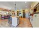 Bright, open kitchen with barstool seating, stainless appliances, and hardwood floors at 9415 N 124Th St, Scottsdale, AZ 85259