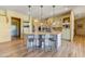 Open kitchen design with a large island, pendant lighting, and hardwood floors at 9415 N 124Th St, Scottsdale, AZ 85259