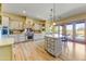 Spacious kitchen boasts custom cabinets, a large island, and stainless steel appliances at 9415 N 124Th St, Scottsdale, AZ 85259