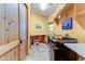Bright laundry room features modern appliances, ample counter space, tiled floors, and a knotty pine door at 9415 N 124Th St, Scottsdale, AZ 85259