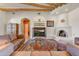 Inviting living room features wood beam ceiling, kiva fireplace, and entertainment center with an eye-catching golf course scene at 9415 N 124Th St, Scottsdale, AZ 85259