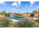 Lush landscaping surrounds the inviting backyard pool and sun lounging area at 9415 N 124Th St, Scottsdale, AZ 85259