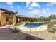 Stunning backyard with a kidney-shaped pool, lush desert landscaping, a covered patio, and inviting seating areas at 9415 N 124Th St, Scottsdale, AZ 85259