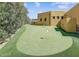 Enjoy outdoor recreation on this home's personal putting green and lush landscaping at 9415 N 124Th St, Scottsdale, AZ 85259