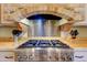 Close-up of the high-end stove featuring a brick surround and stainless steel hood at 9415 N 124Th St, Scottsdale, AZ 85259