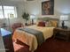 Cozy bedroom with bright natural light, lamps, carpet, and an inviting plush bed at 9679 W Cinnabar Ave # B, Peoria, AZ 85345