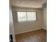 Cozy bedroom featuring hardwood floors and a bright window with horizontal blinds at 9679 W Cinnabar Ave # B, Peoria, AZ 85345