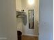 Functional closet with shelving, clothes hangers, and a mirror for storage convenience at 9679 W Cinnabar Ave # B, Peoria, AZ 85345
