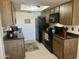 Bright kitchen boasts black appliances, wood cabinetry, a skylight and coordinated decor creating a functional cooking space at 9679 W Cinnabar Ave # B, Peoria, AZ 85345