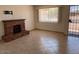 Bright living room showcasing a brick fireplace and a large window for natural light at 9679 W Cinnabar Ave # B, Peoria, AZ 85345