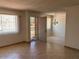 Living room view showing a large window and a dining area with chandelier at 9679 W Cinnabar Ave # B, Peoria, AZ 85345