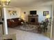 Inviting living room features a brick fireplace, comfortable sofa, stylish seating and attractive decor at 9679 W Cinnabar Ave # B, Peoria, AZ 85345