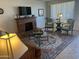 Comfortable living area featuring a brick fireplace, decorative seating, an attractive area rug, and natural lighting at 9679 W Cinnabar Ave # B, Peoria, AZ 85345