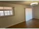 Inviting living area with wood floors and windows equipped with blinds, offering natural light at 9679 W Cinnabar Ave # B, Peoria, AZ 85345