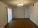 Spacious living room with wood floors and a sliding glass door providing ample natural light at 9679 W Cinnabar Ave # B, Peoria, AZ 85345